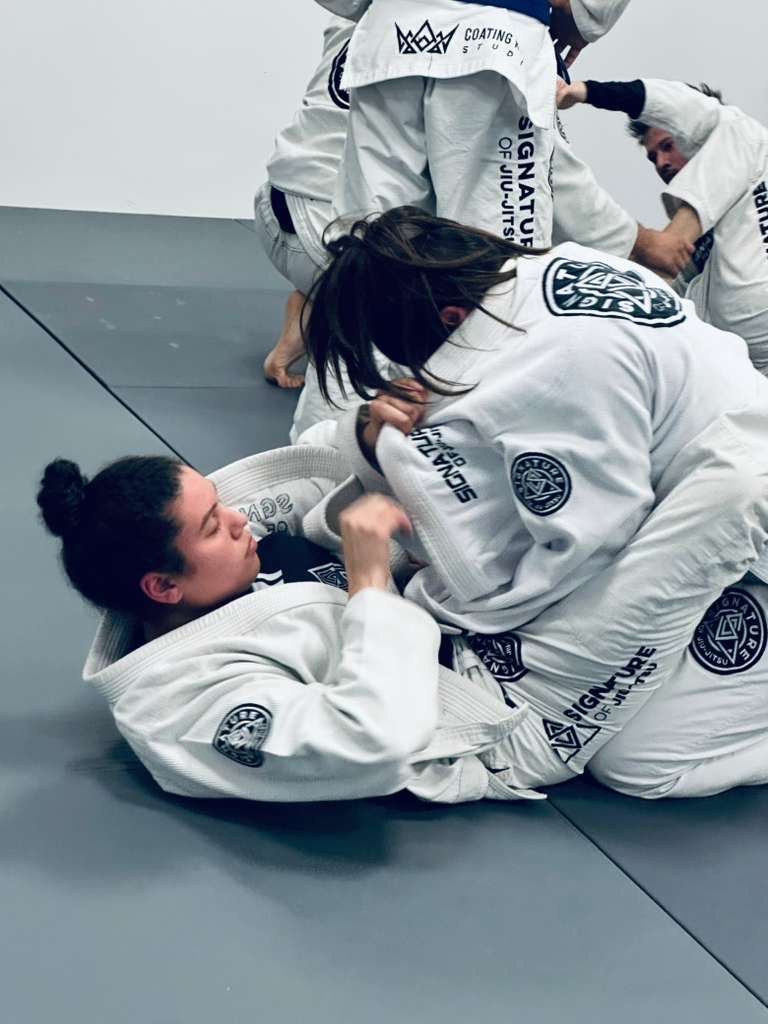 Students drilling Brazilian Jiu-Jitsu at Signature of Jiu-Jitsu in Belmont, CA to build calm, real-world confidence.