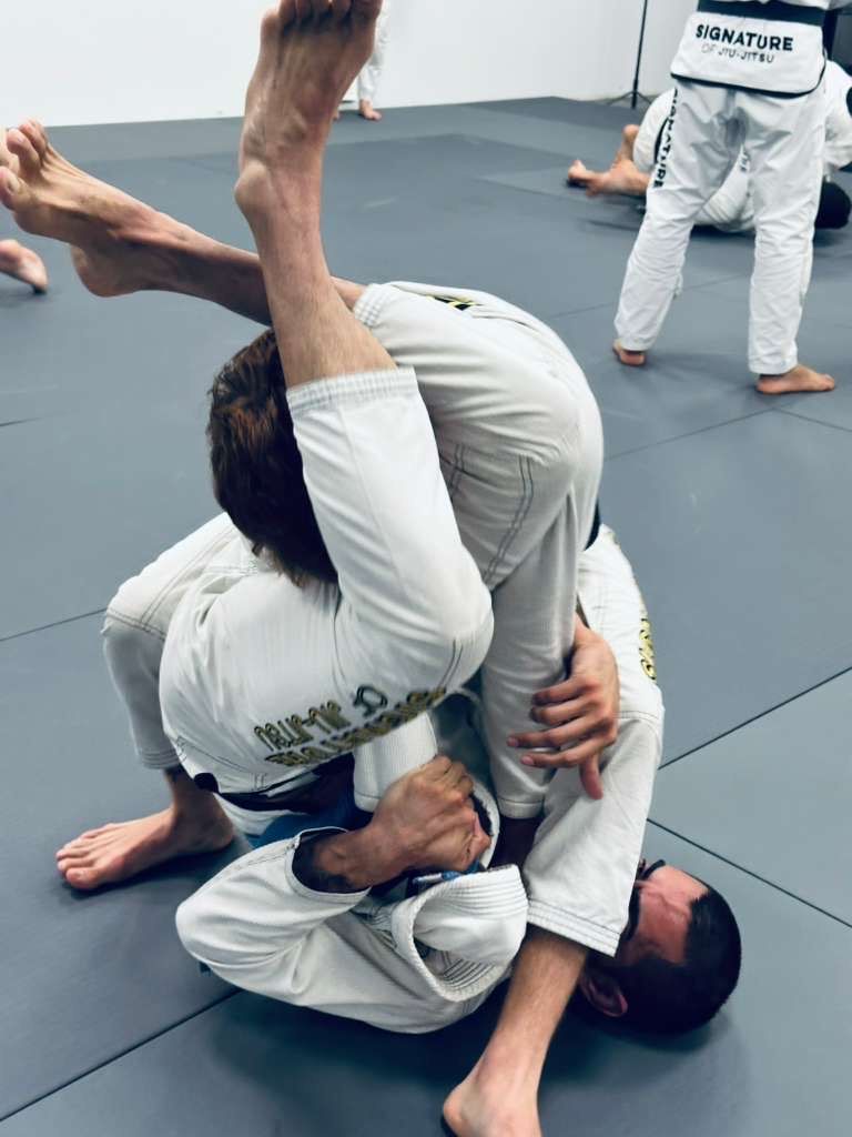 Students practice Brazilian Jiu-Jitsu drills at Signature of Jiu-Jitsu in Belmont, CA.