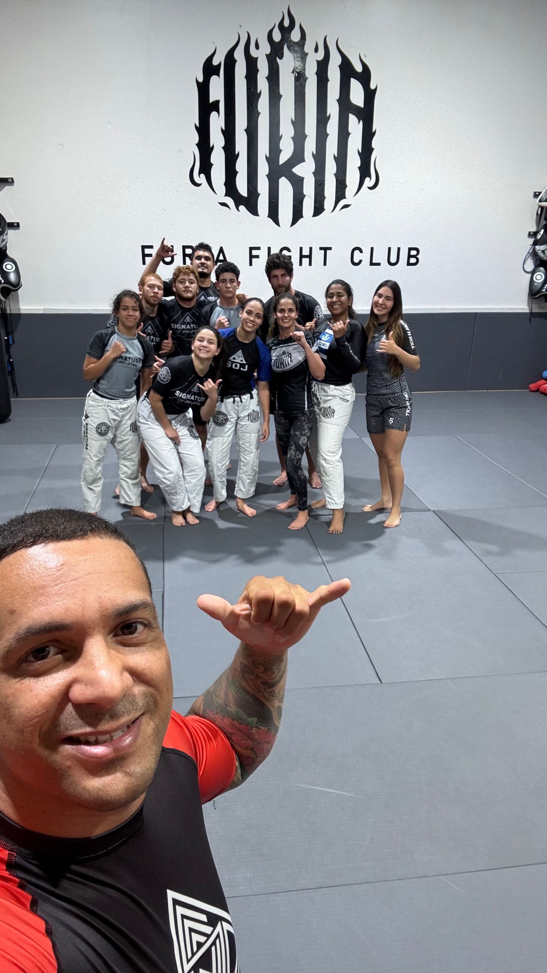 Adults practicing Brazilian Jiu-Jitsu at Signature of Jiu-Jitsu in Belmont, CA, building energy.