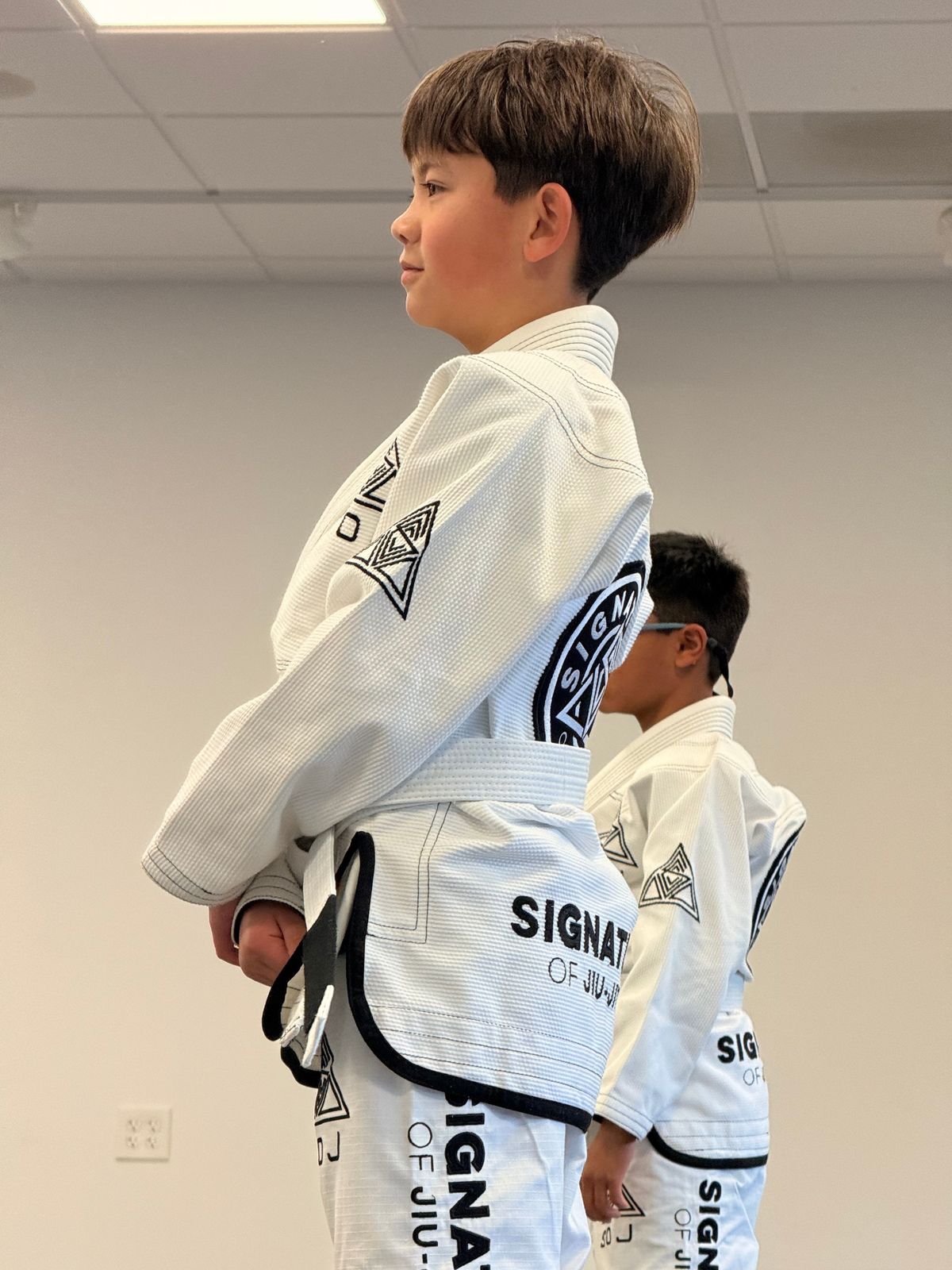 Kids practice partner drills at Signature of Jiu-Jitsu in Belmont, CA, building confidence.