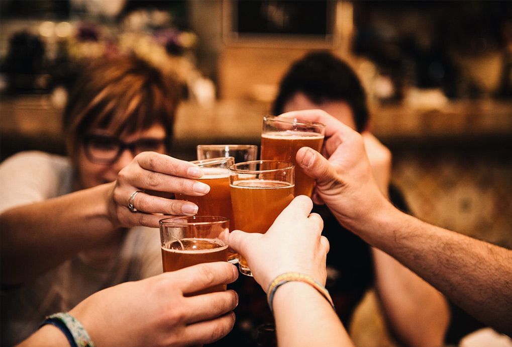 A Group Of People Are Toasting With Beer Glasses — Maryborough Cricket Club In Maryborough, QLD