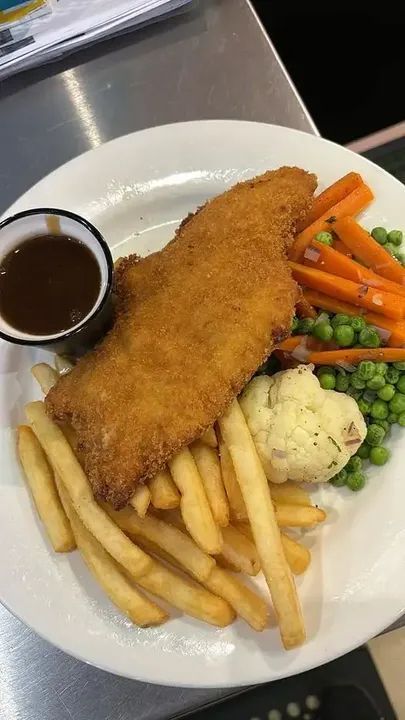 A Chicken Schnitzel On A White Plate With Chips— Maryborough Cricket Club In Maryborough, QLD