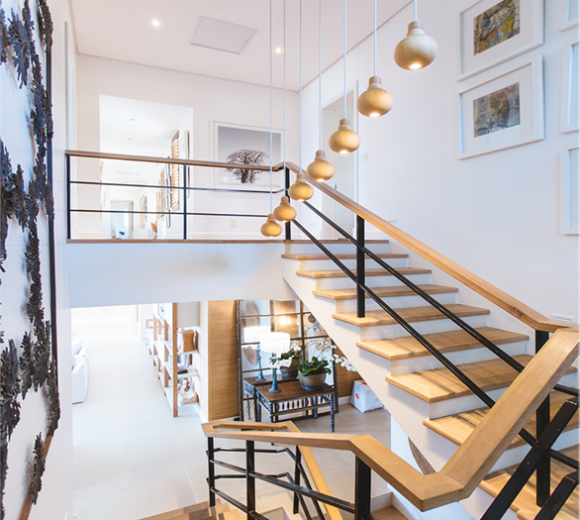 A staircase with wooden steps and a black railing