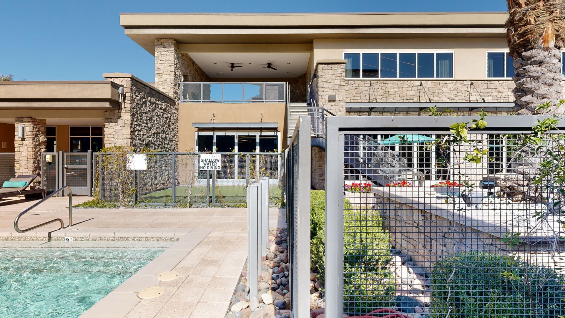 A large house with a swimming pool in front of it.