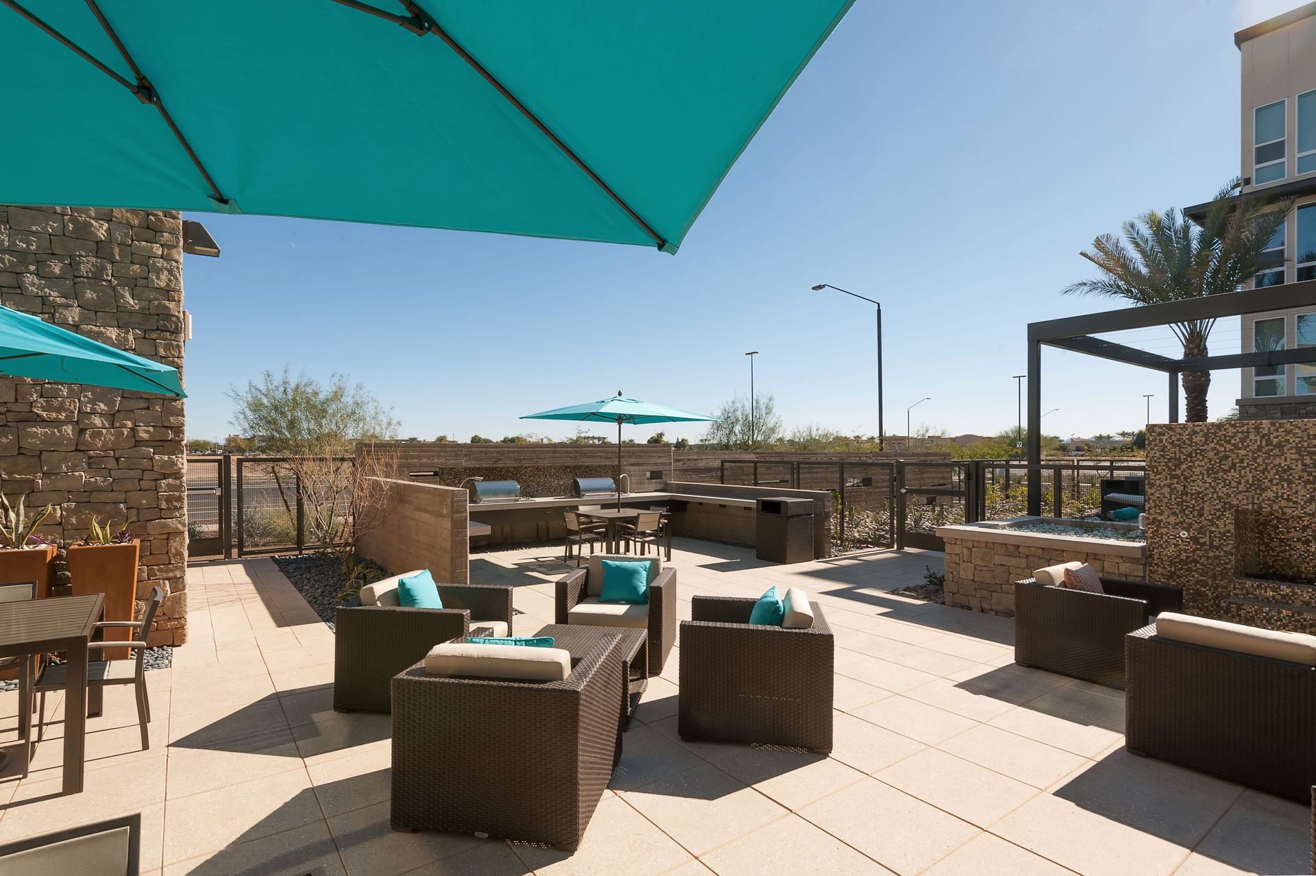 A patio with a lot of furniture and umbrellas