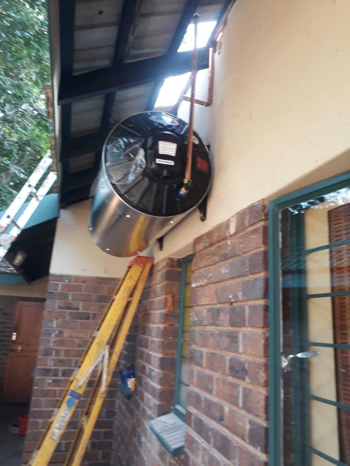 Electric geyser mounted on an outside wall of a home