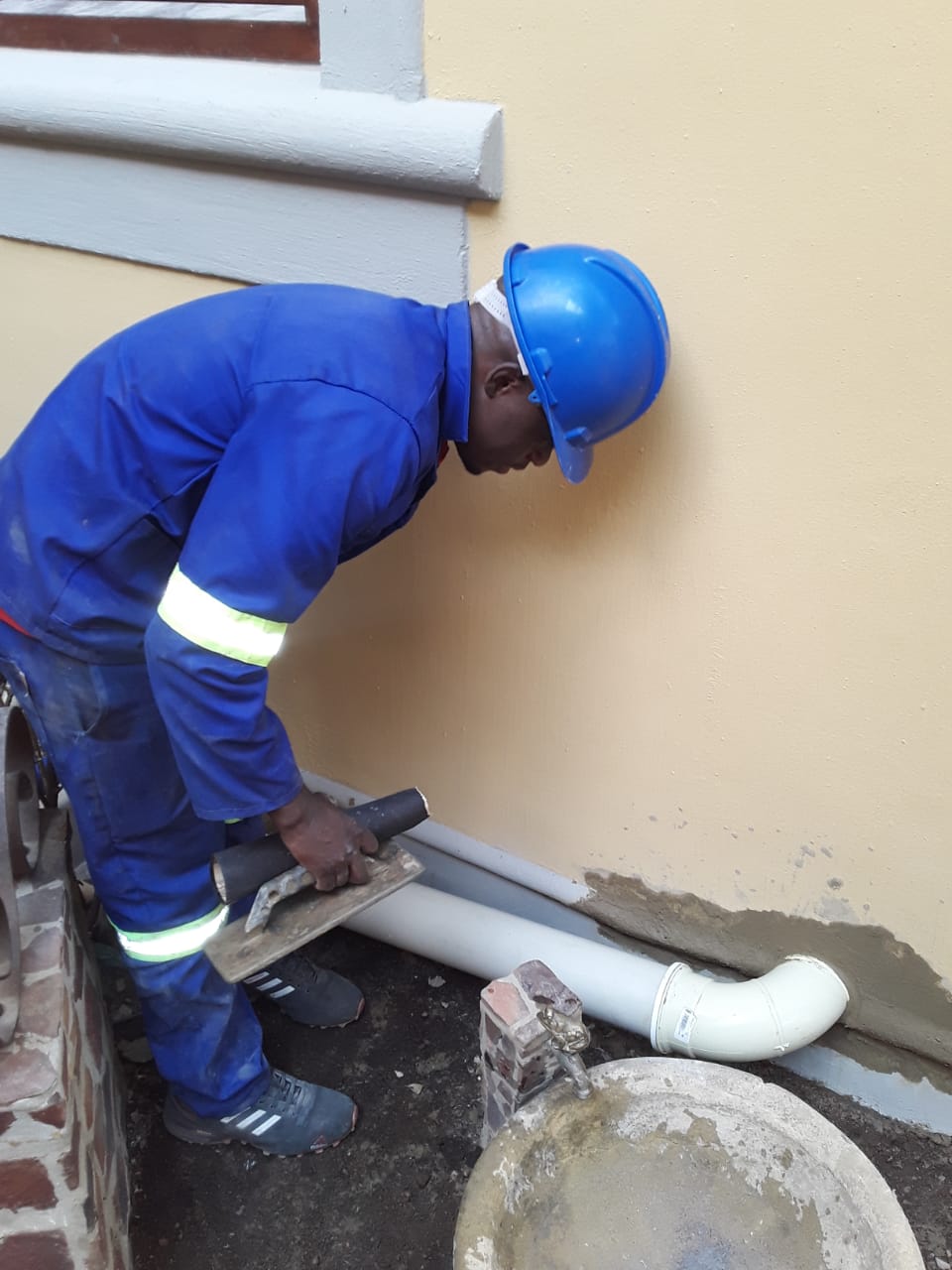 worker installing plumbing pipes