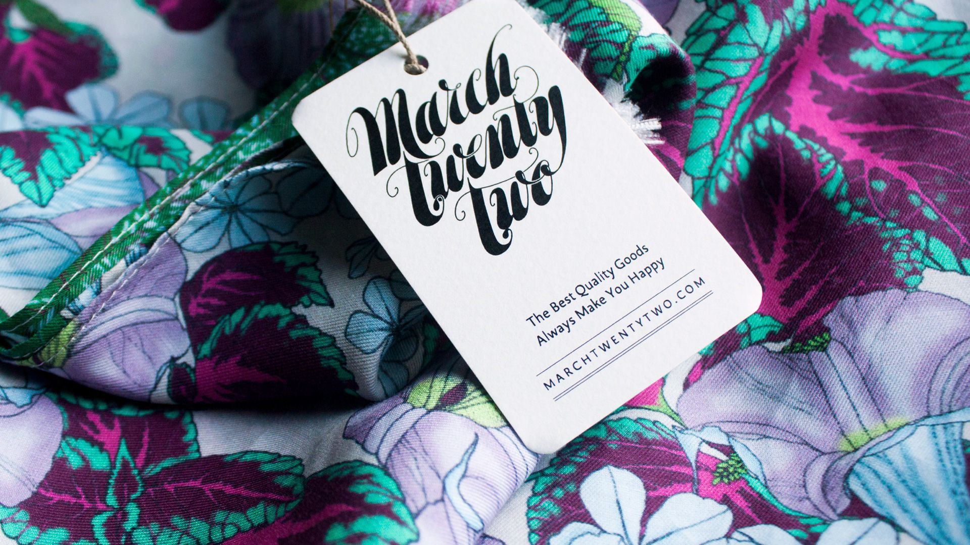 White tag on colorful floral fabric reading “Maui Waui”