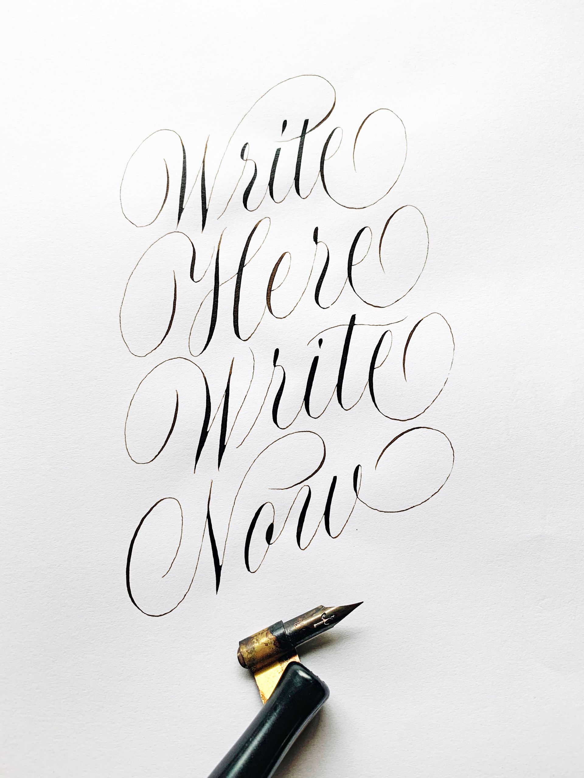 Calligraphy reading “Write More Write Now” beside a fountain pen nib