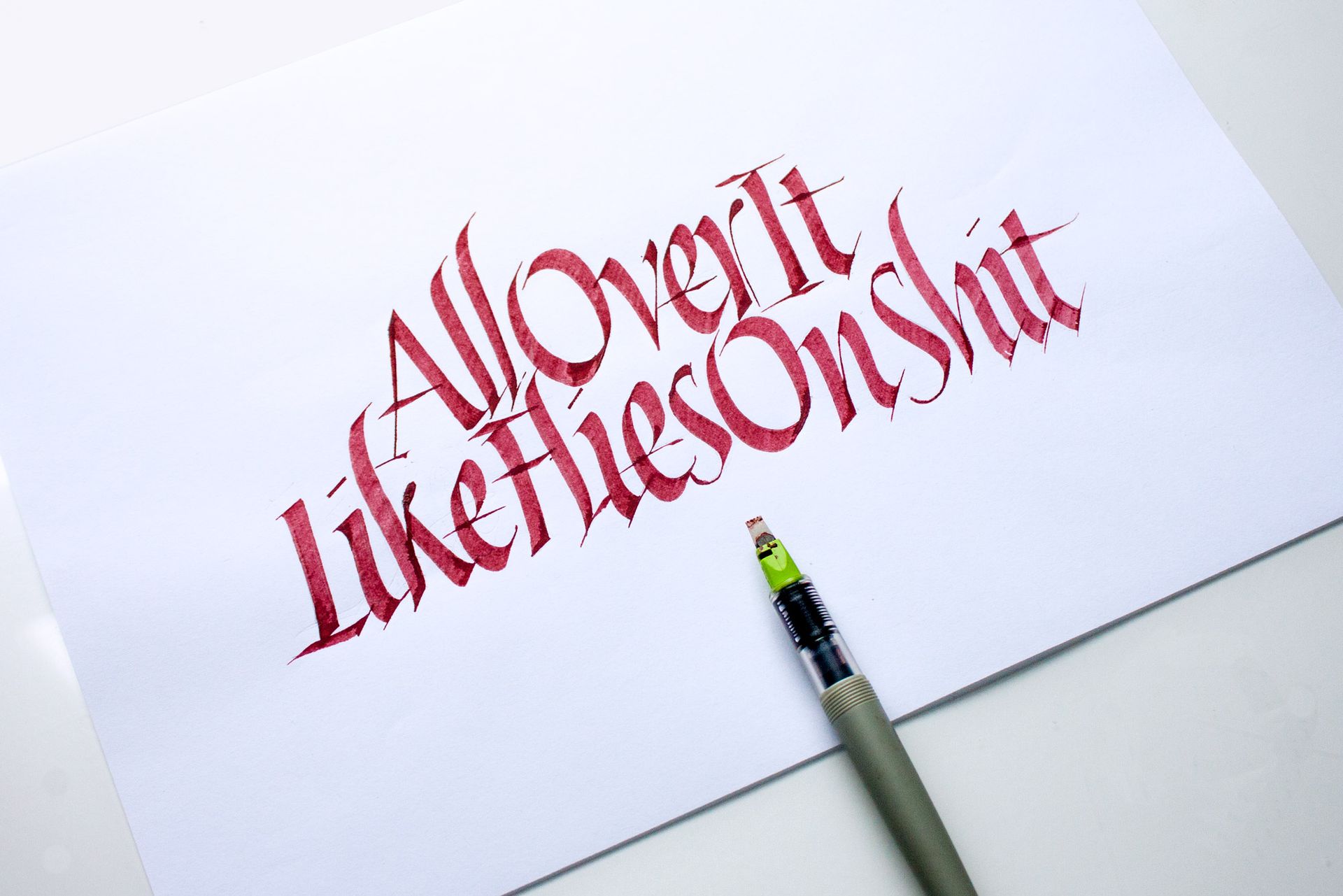 Calligraphy on white paper reads 