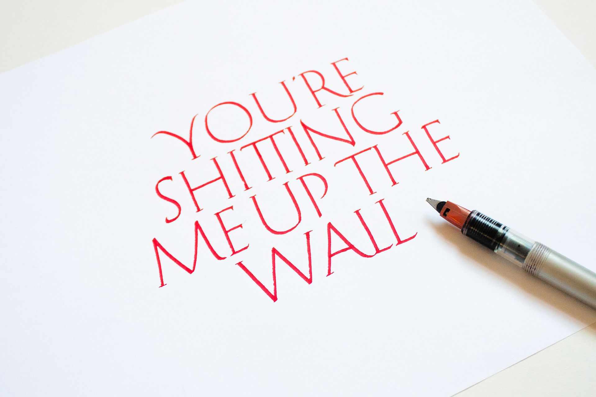 A piece of white paper with the red text 