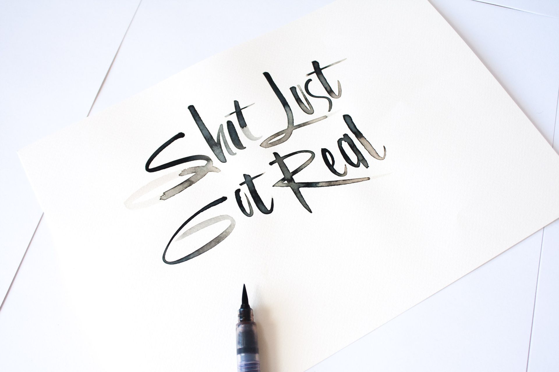 A piece of paper with the hand-lettered phrase