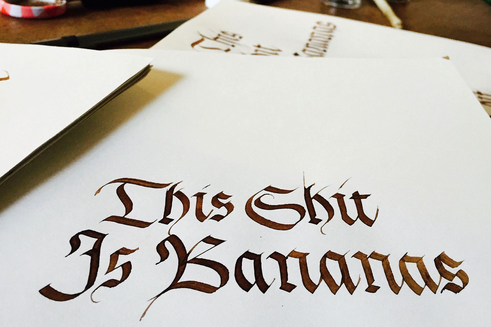 A hand-drawn artistic lettering piece on white paper with a black pen showing the phrase