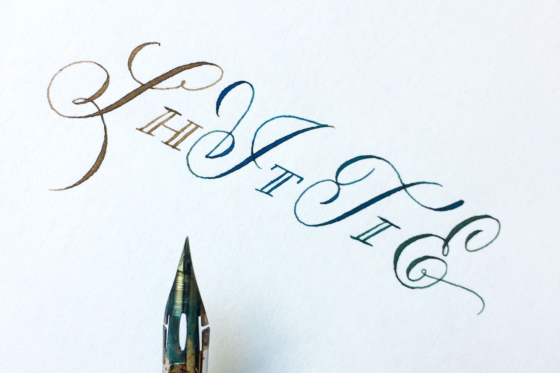 A calligraphy pen tip sits below elegant, hand-lettered text reading 