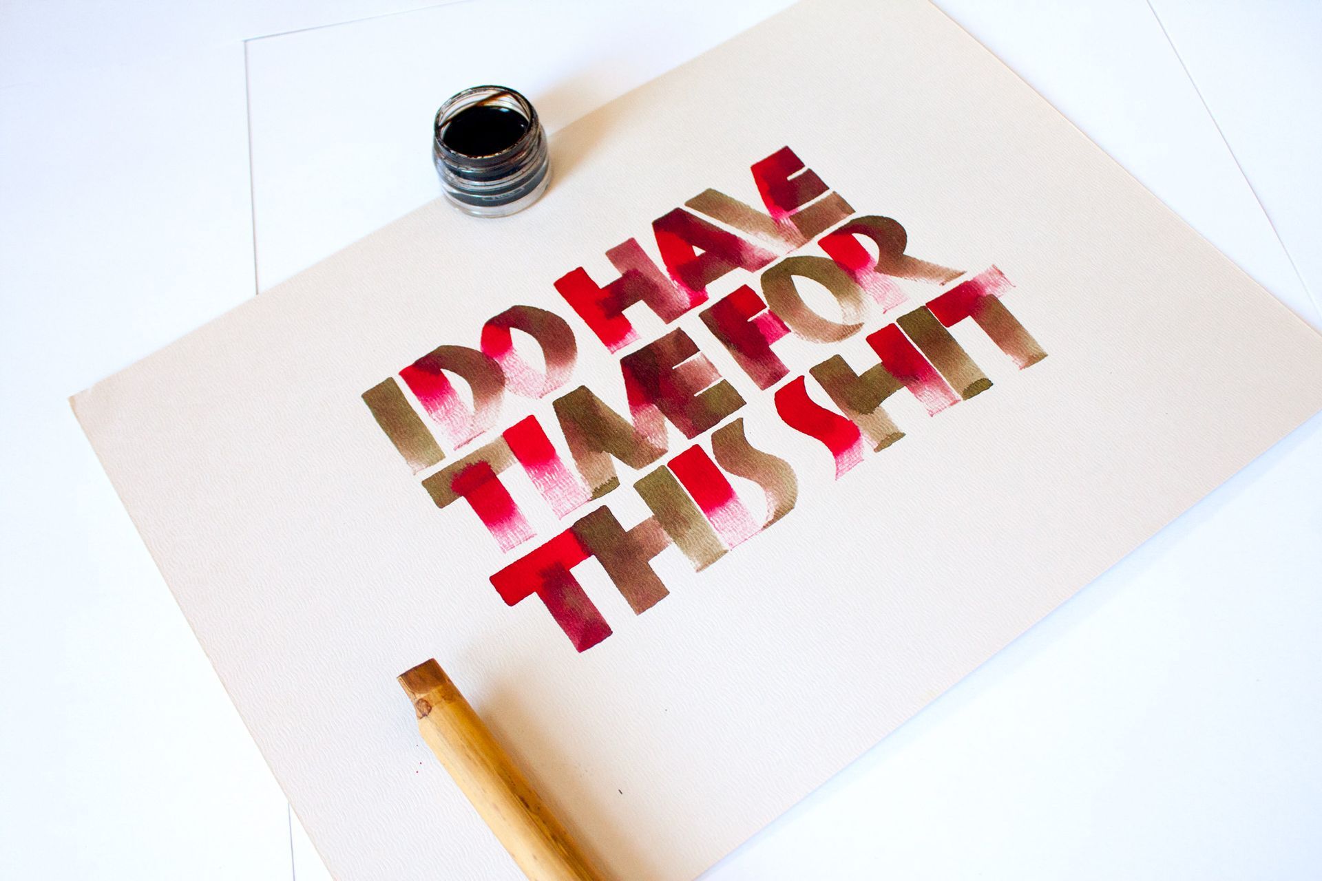 A calligraphy piece on white paper reads 
