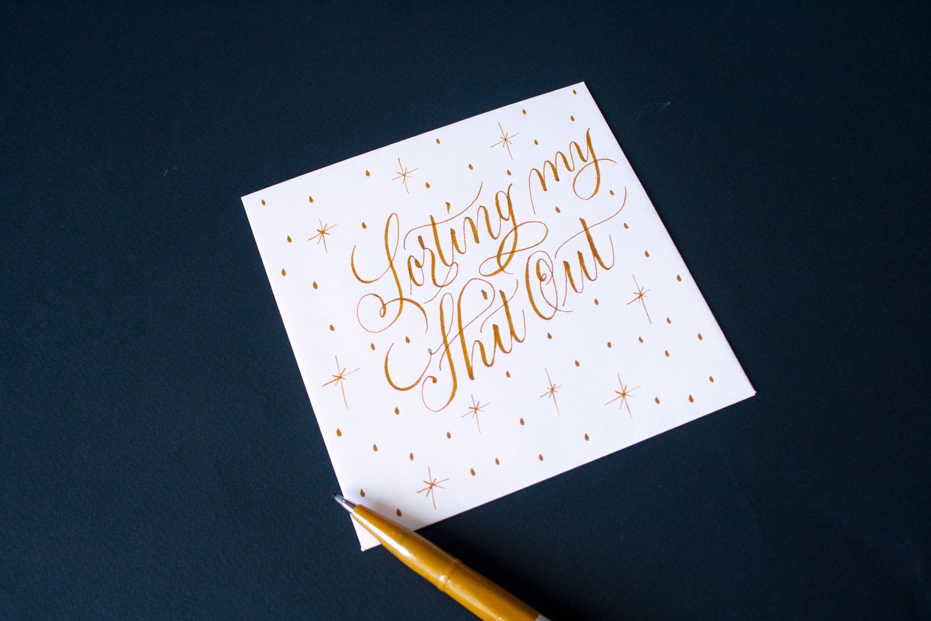 A gold-ink calligraphy note reading 