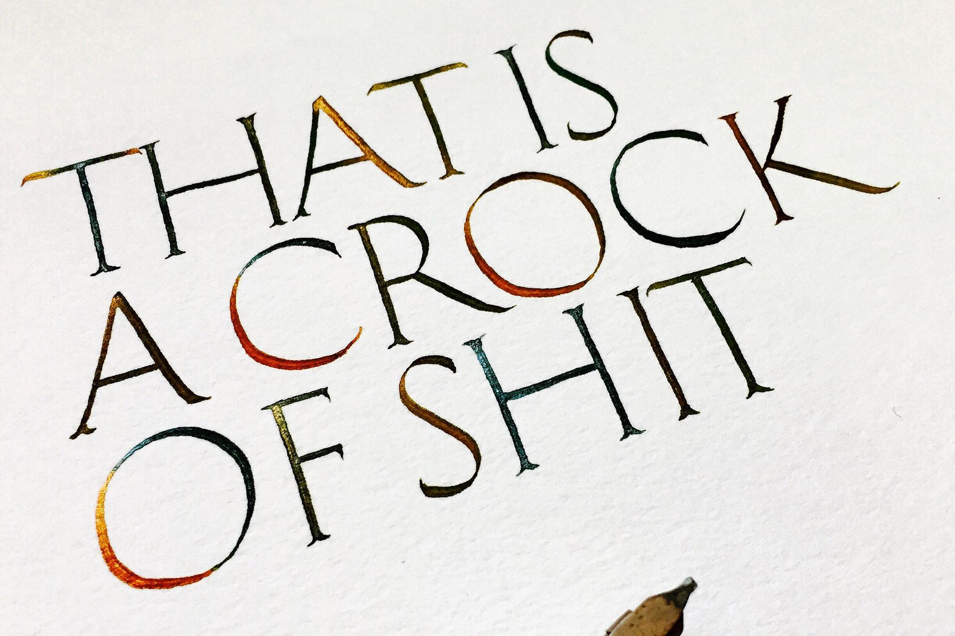 A close-up of calligraphy written in an orange-to-black gradient ink that reads: