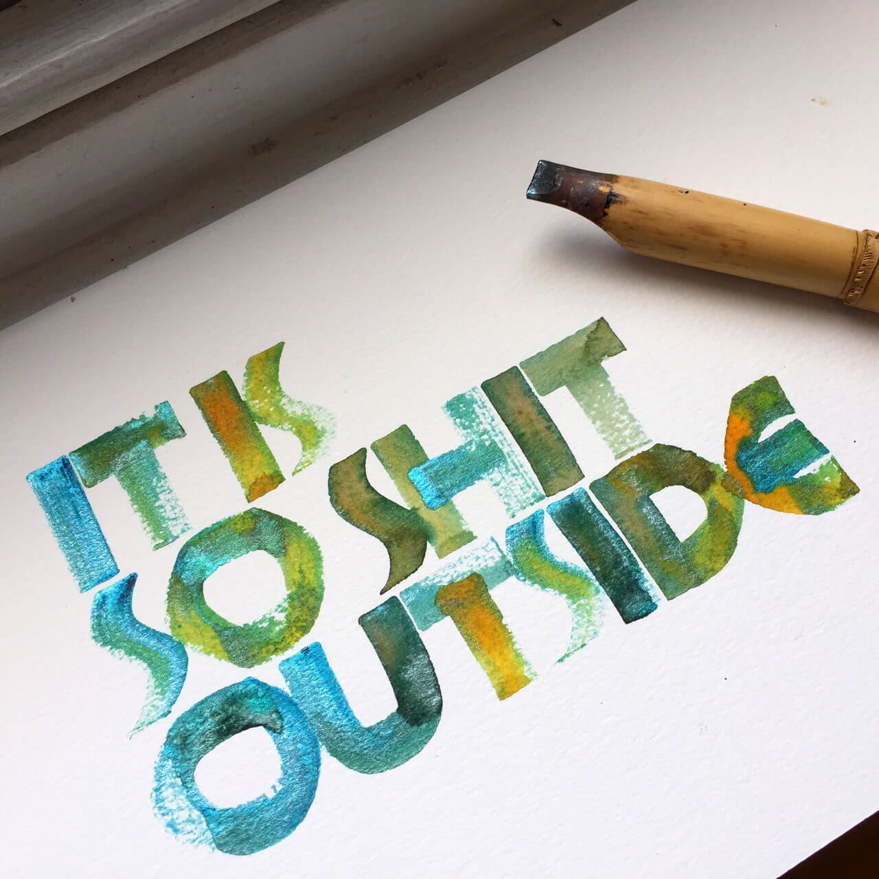 Calligraphic lettering in blue, green, and yellow watercolor on white paper reads