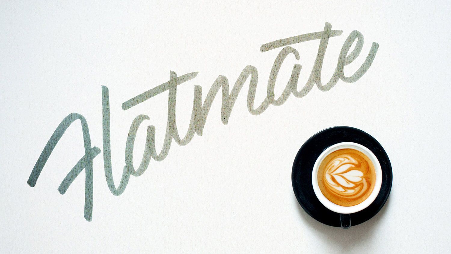 “Flatmate” handwritten wordmark beside a top-down coffee cup on a white background