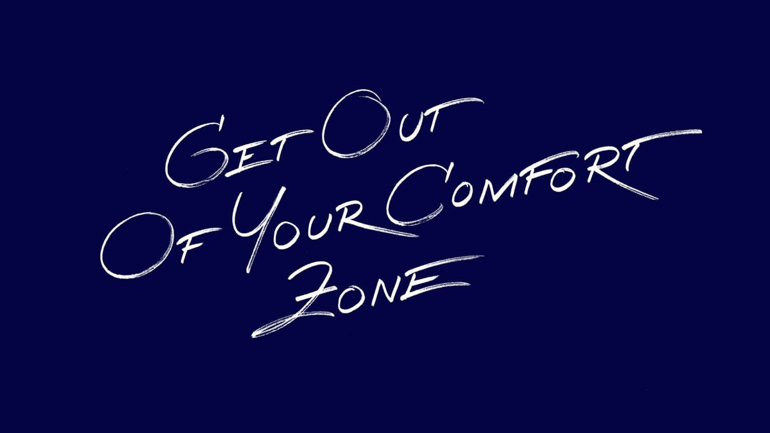 White handwritten quote on a dark blue background: “Get out of your comfort zone.”