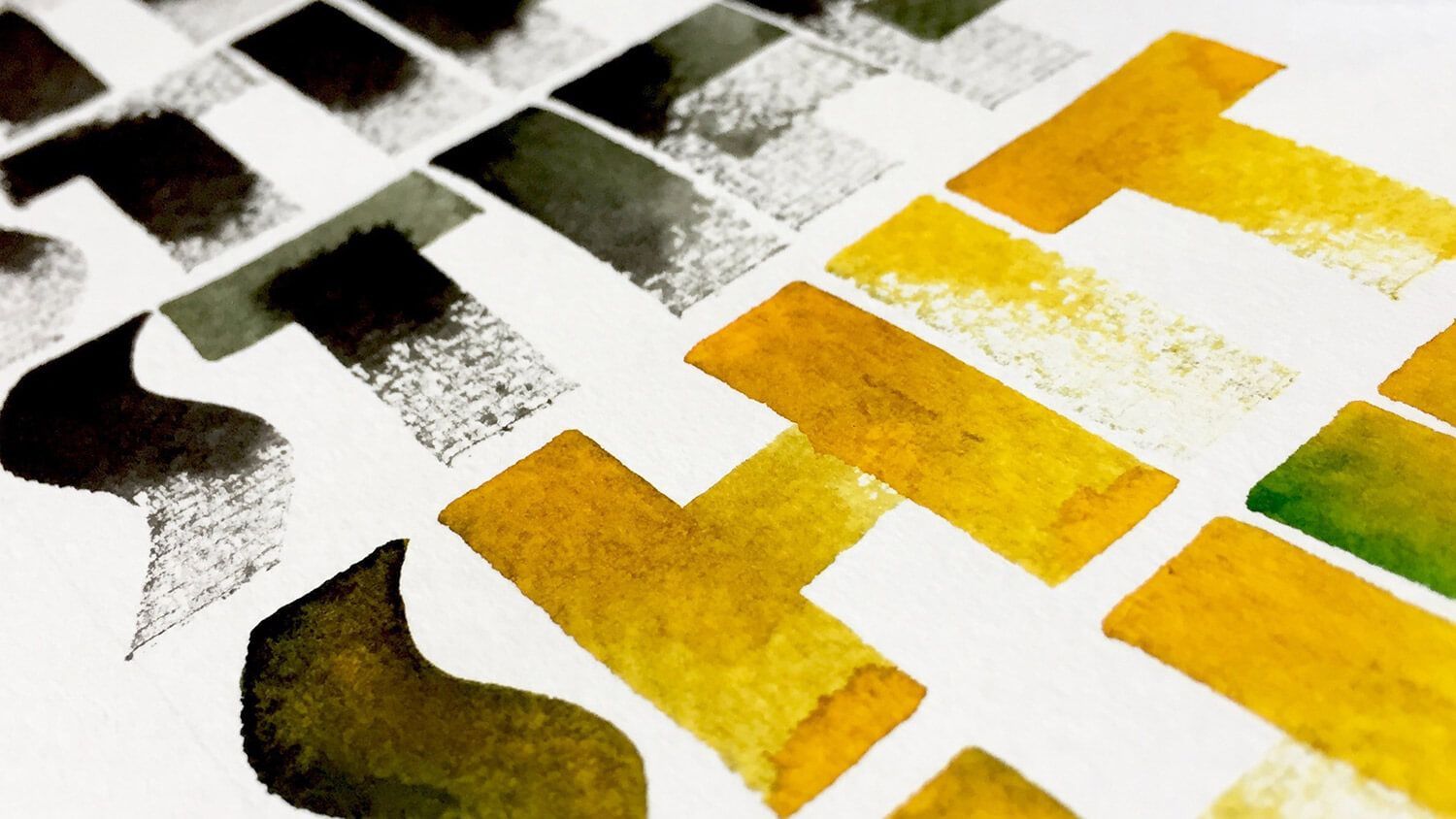 Abstract geometric print with yellow, black, and gray blocks on textured white paper