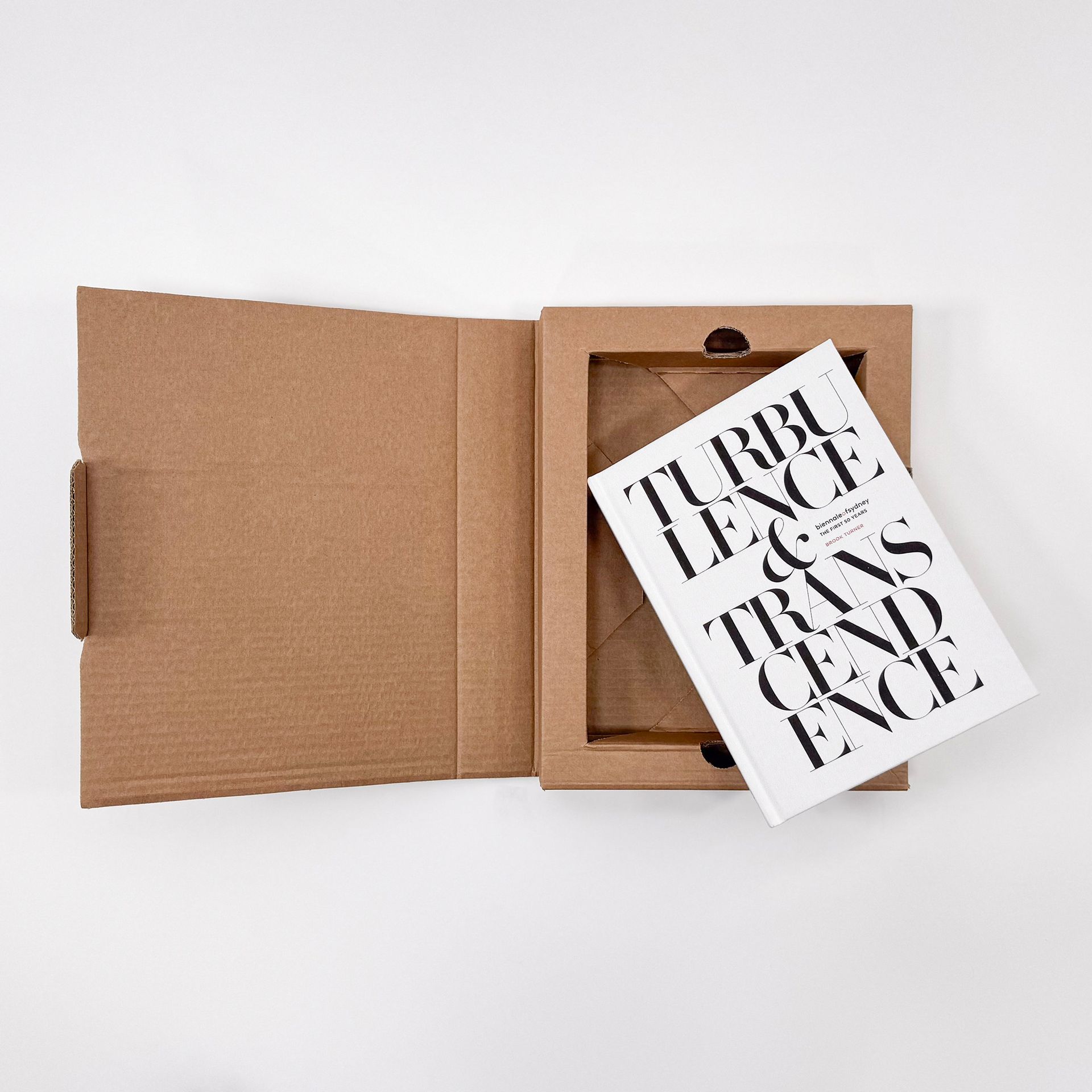 Open kraft envelope with a black-and-white card partially pulled out on a white background