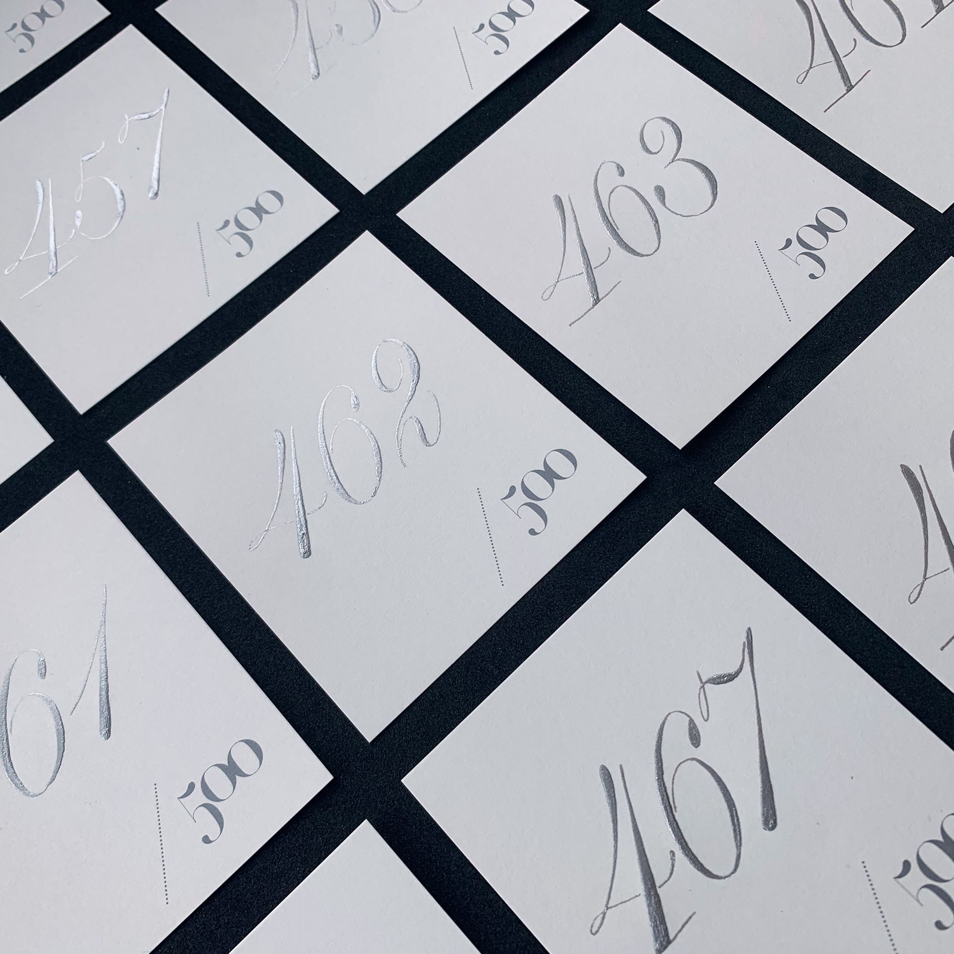 White numbered squares arranged diagonally on a dark grid, showing handwritten numbers like 467, 163, and 103.