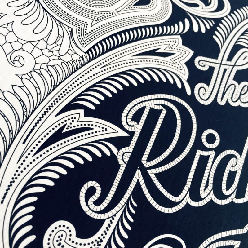 Intricate white paisley and floral line art on a dark blue background, featuring the partial text 