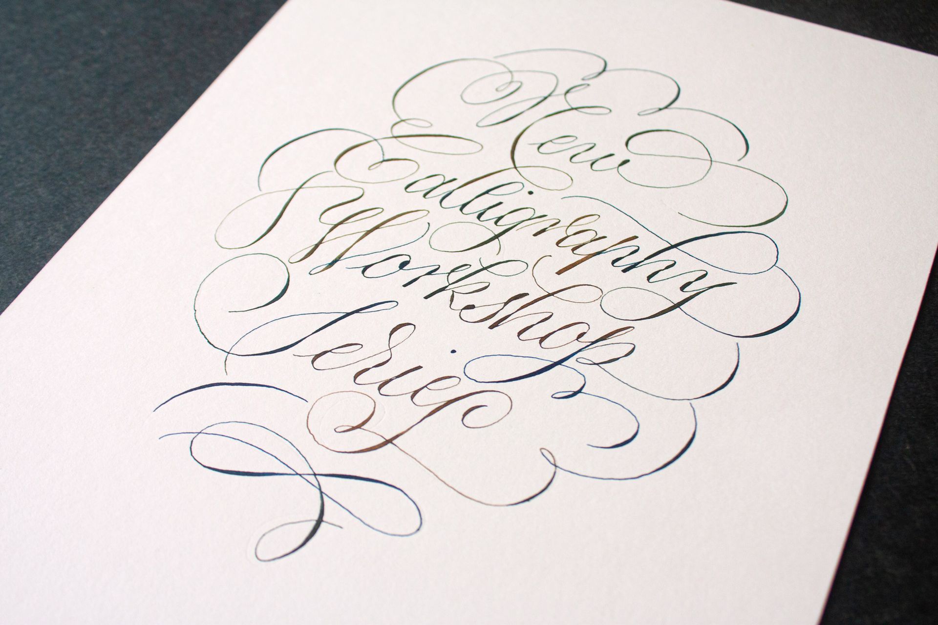 Calligraphy reading “Believe in yourself” on white paper with decorative flourishes