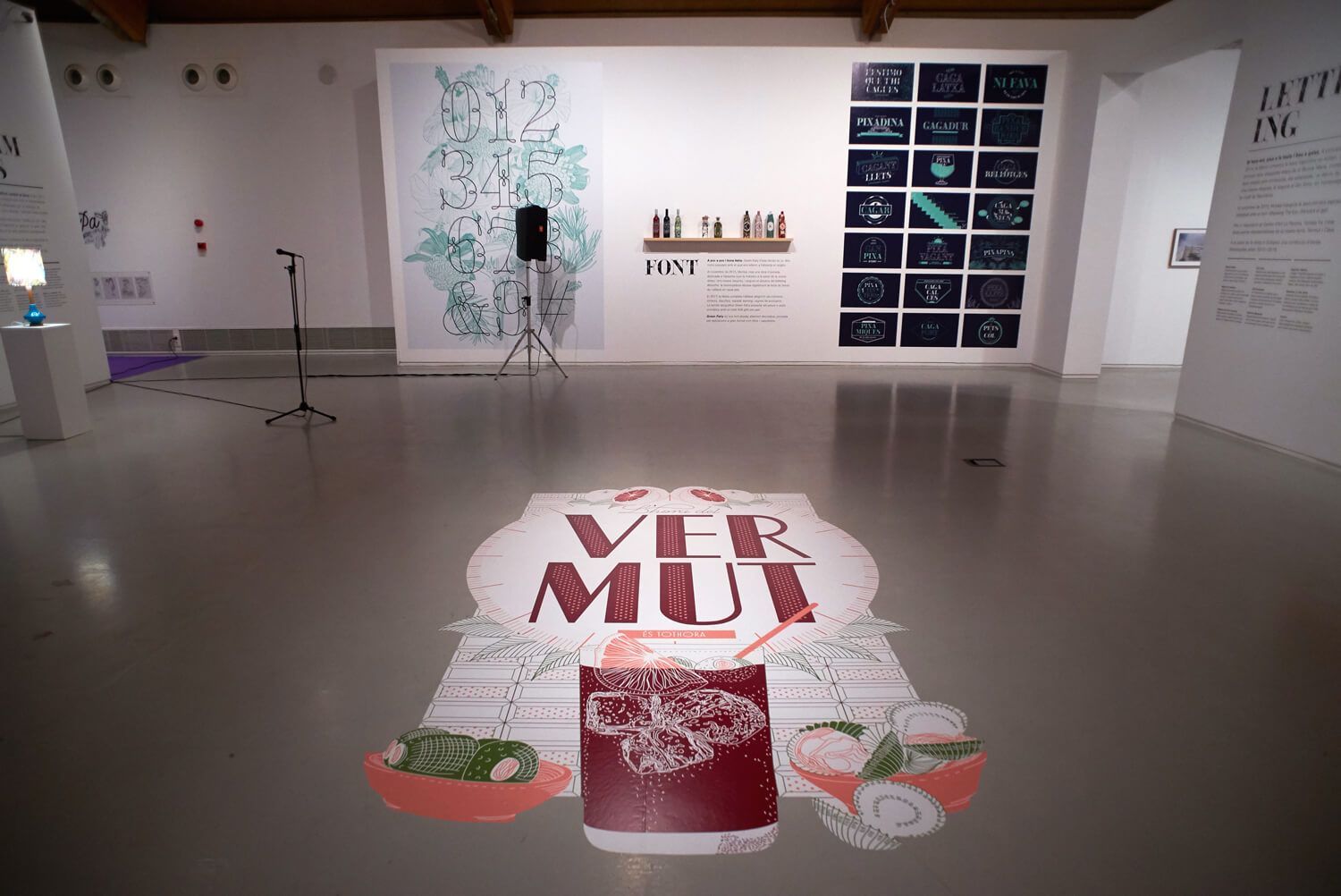 Art gallery floor with a large “MFR MUI” mural and contemporary wall installations.