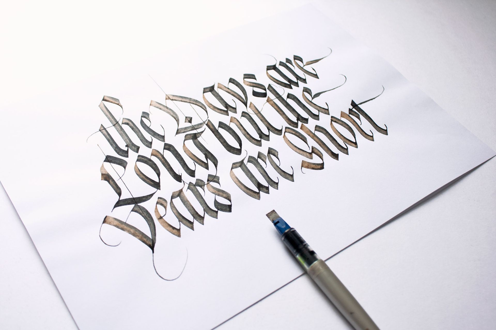 Calligraphy practice on white paper with a brush pen writing the phrase “the only thing to fear is fear itself”