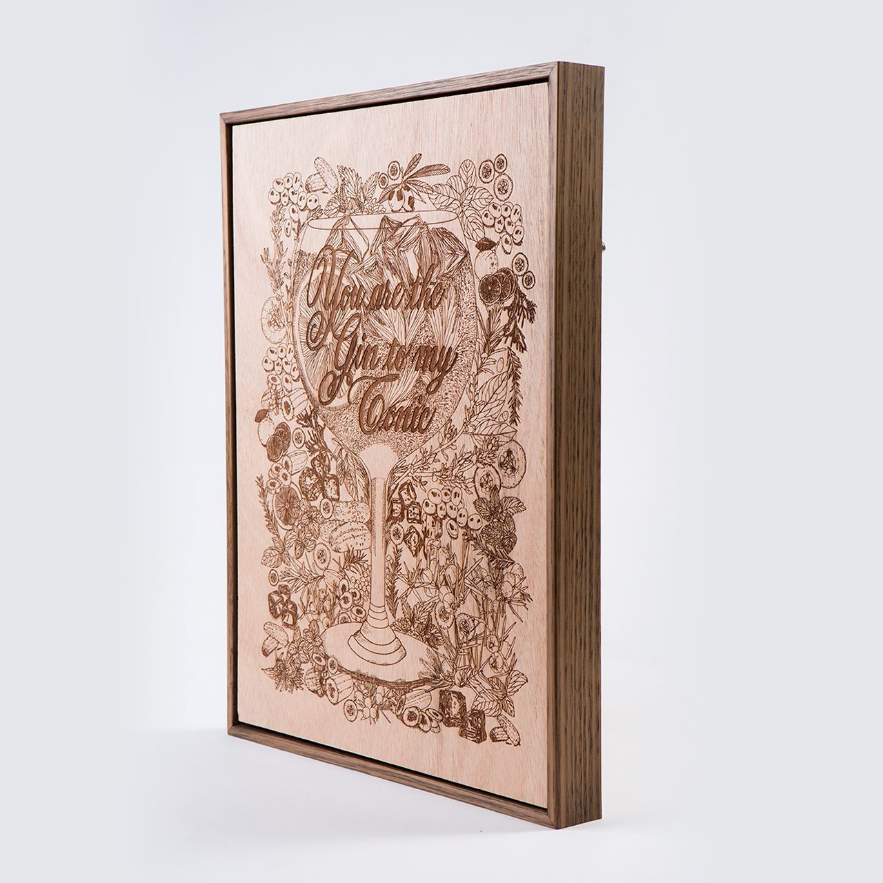Laser-etched wooden plaque with an ornate floral tree design, shown at an angle