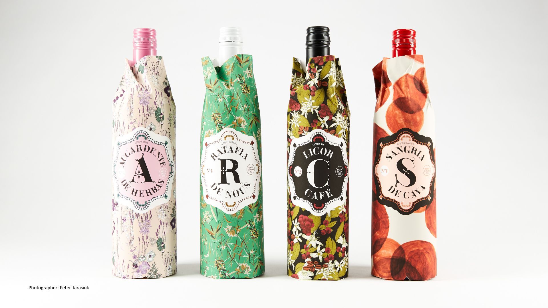 Green Fairy Font. Four colorful patterned bottles with black labels on a white background
