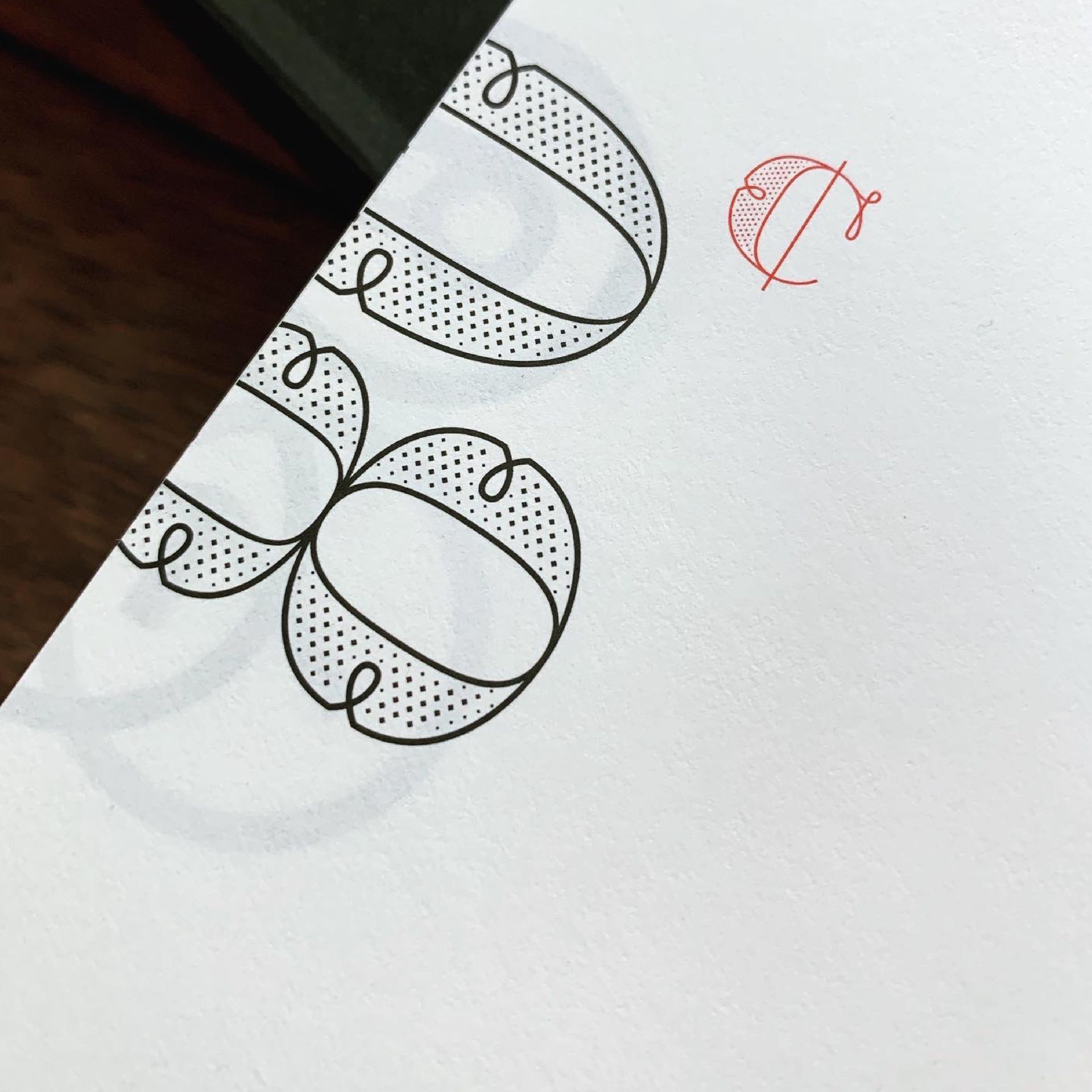 Green Fairy Font. Black-and-white doodle of overlapping patterned circles on paper, with a small red sketch nearby.