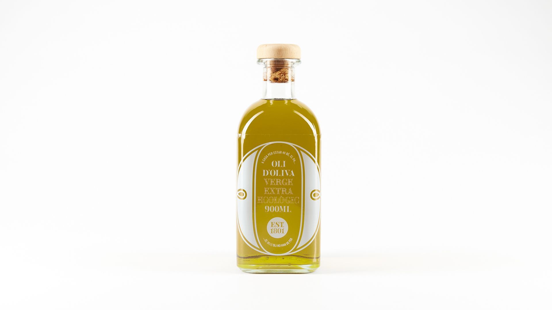 A clear glass bottle with golden liquid and a cork stopper on a white background.