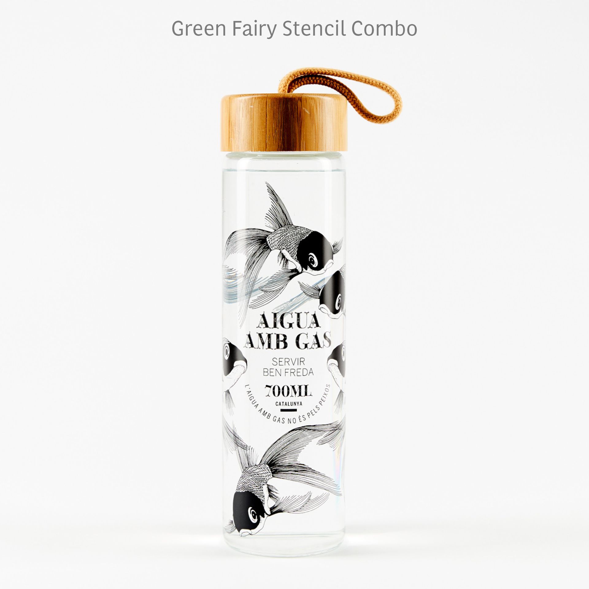 Clear glass spray bottle with bamboo cap and loop, black floral design, labeled “Aigua Amb Gas.”