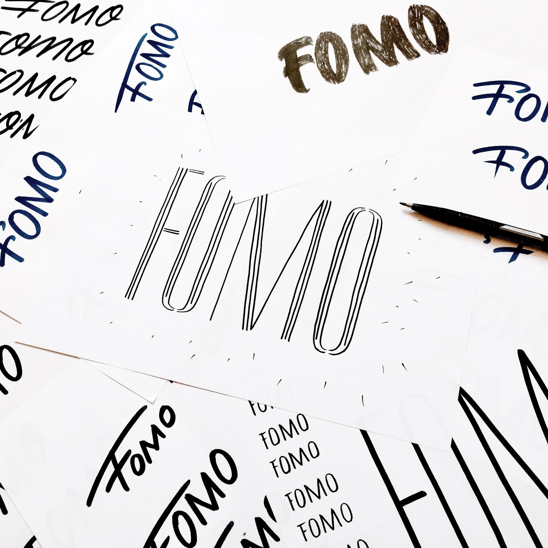 A sheet covered in various sketches of the word