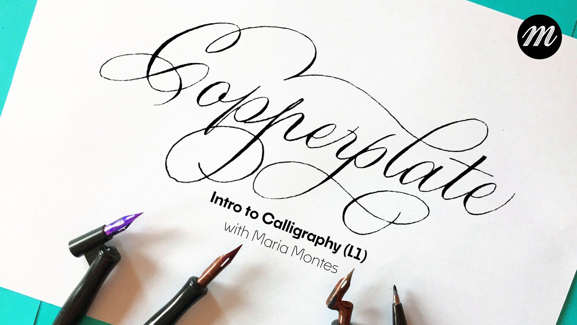 Handwritten “Calligraphy” on white paper with pen nibs and a brush pen at the bottom