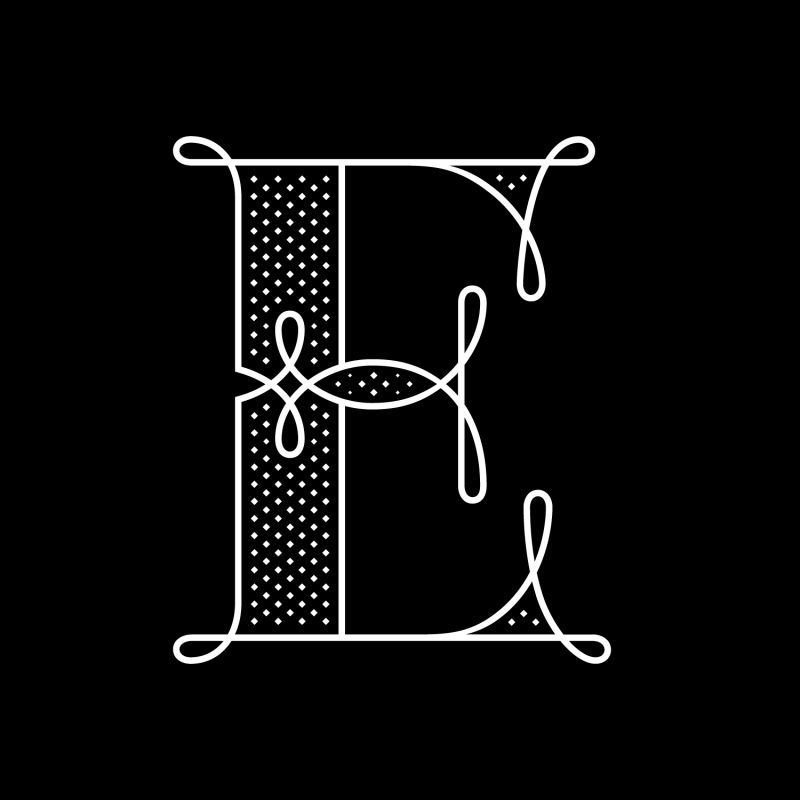 A white, ornate, decorative letter 