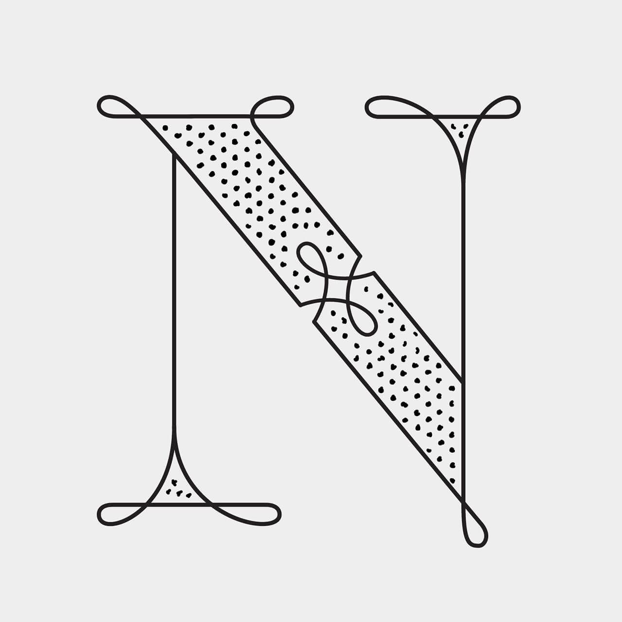 Green Fairy Font. Stylized letter N with dotted diagonal stripe and mirrored decorative serifs in black and white.