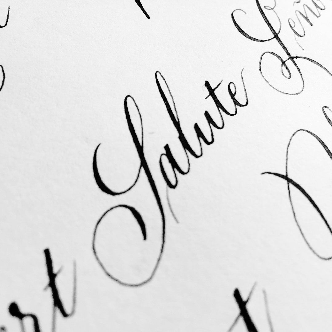Close-up of cursive text on a pale green background reading “Mojito” and “Made!”