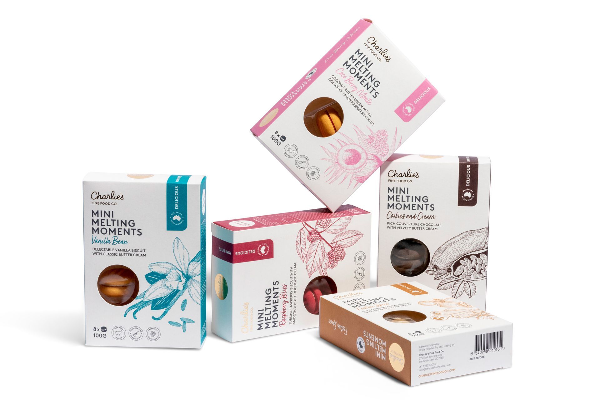 Assorted cosmetic boxes in white, pink, teal, brown, and gray, arranged in a product display.