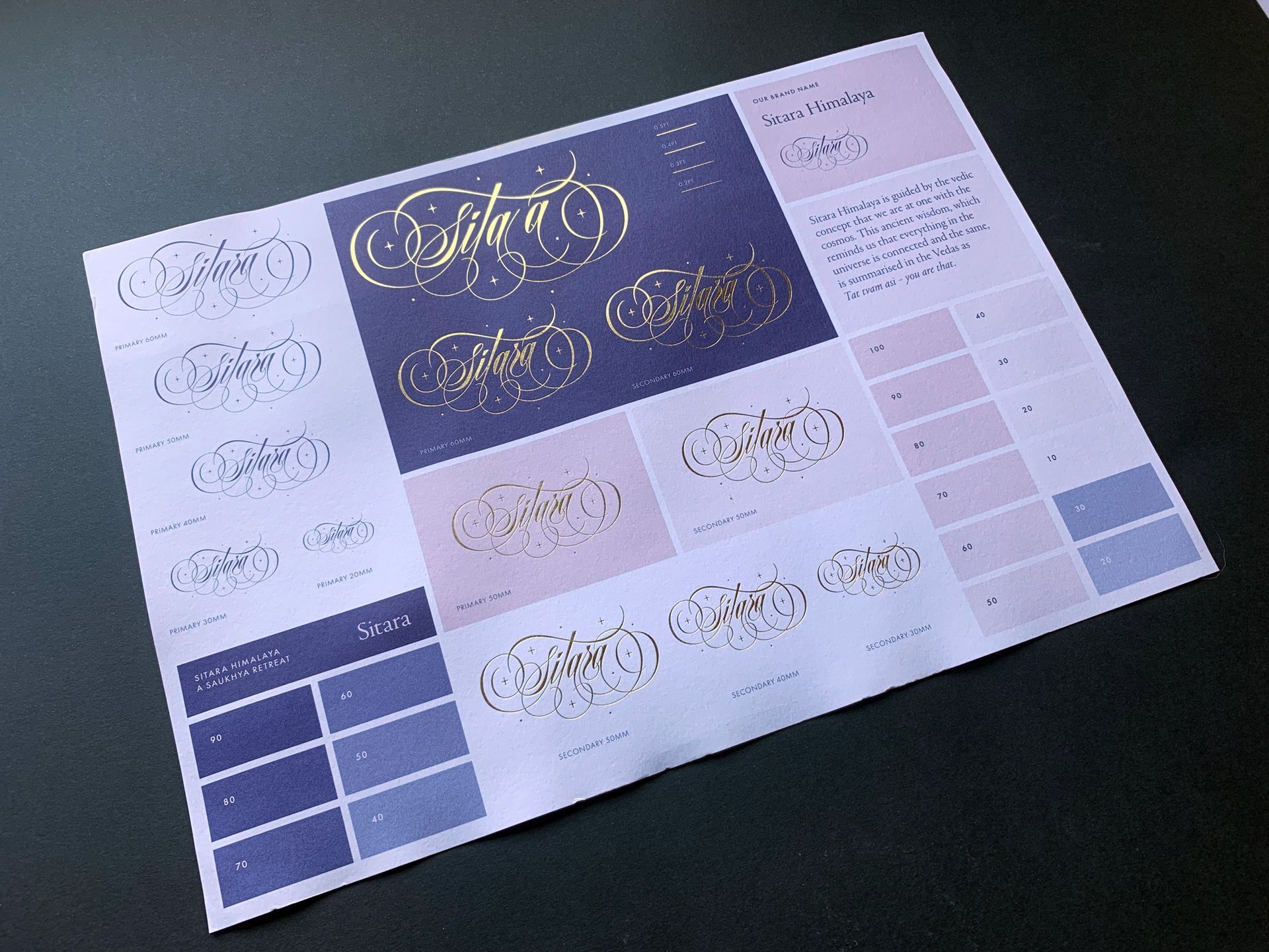 Calligraphy logo design sheet with gold lettering samples on white and lavender backgrounds