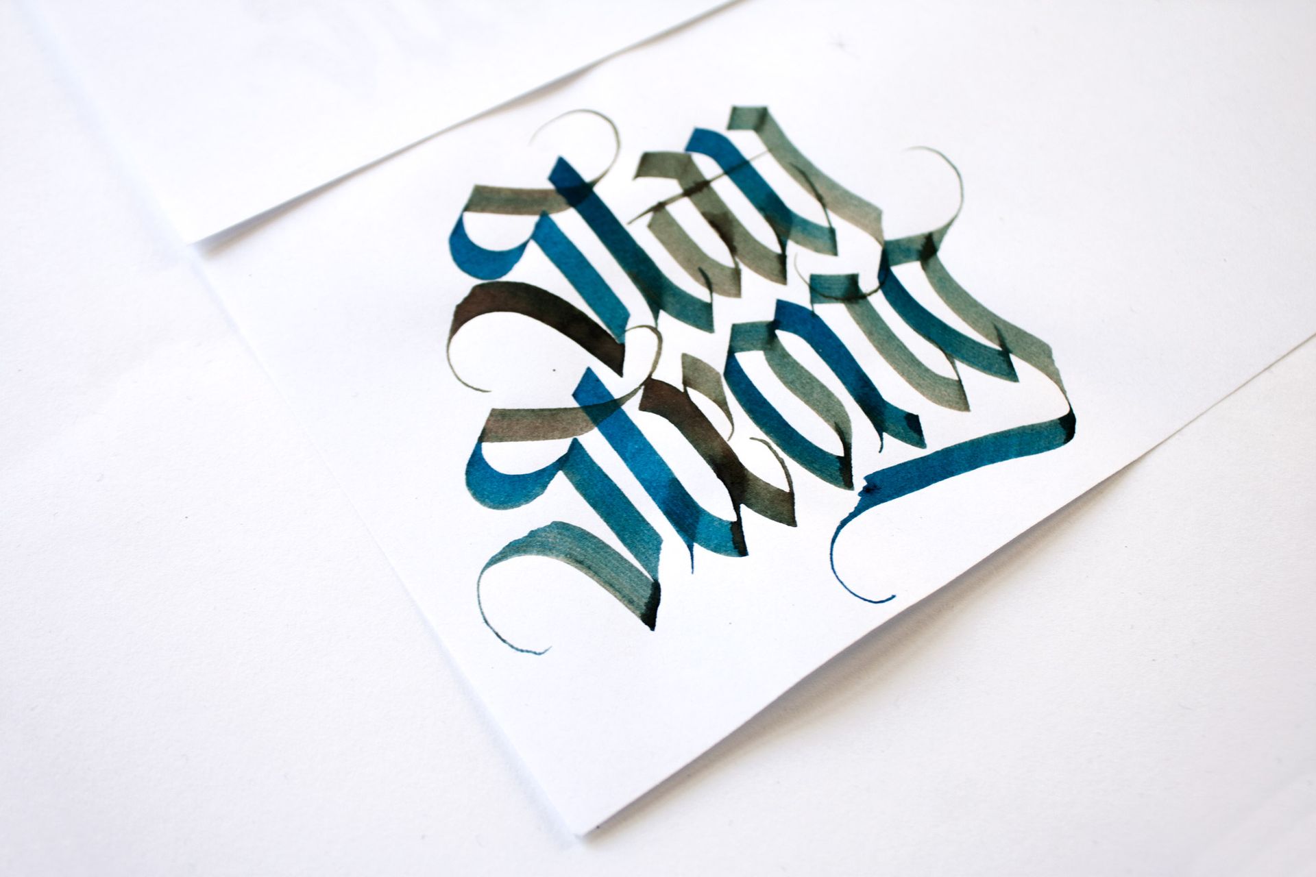 A sunset over the ocean with the cursive white text,