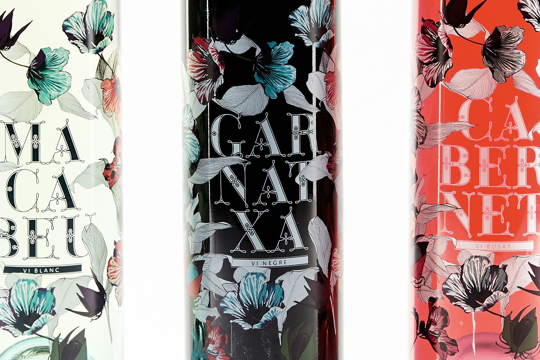 Three floral-scented bottles in white, black, and coral with bold typography