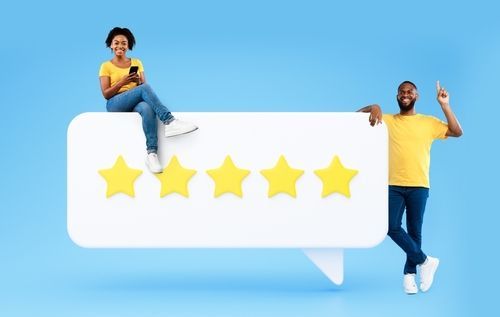 A man and a woman are standing next to a speech bubble with five stars on it.