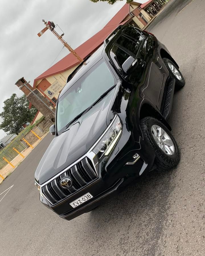 Black SUV Parked on A Street Outside a Building — Diamond Glow Auto Detailing in Armidale, NSW