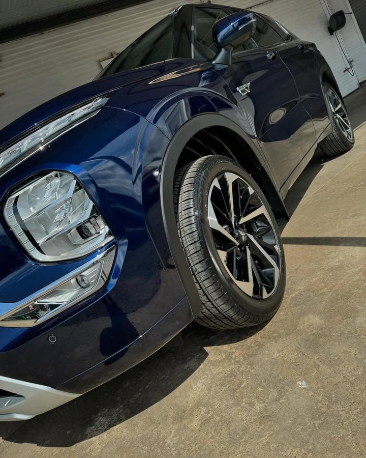 Blue SUV Parked in A Garage Front Left View on A Concrete Floor — Diamond Glow Auto Detailing in Armidale, NSW