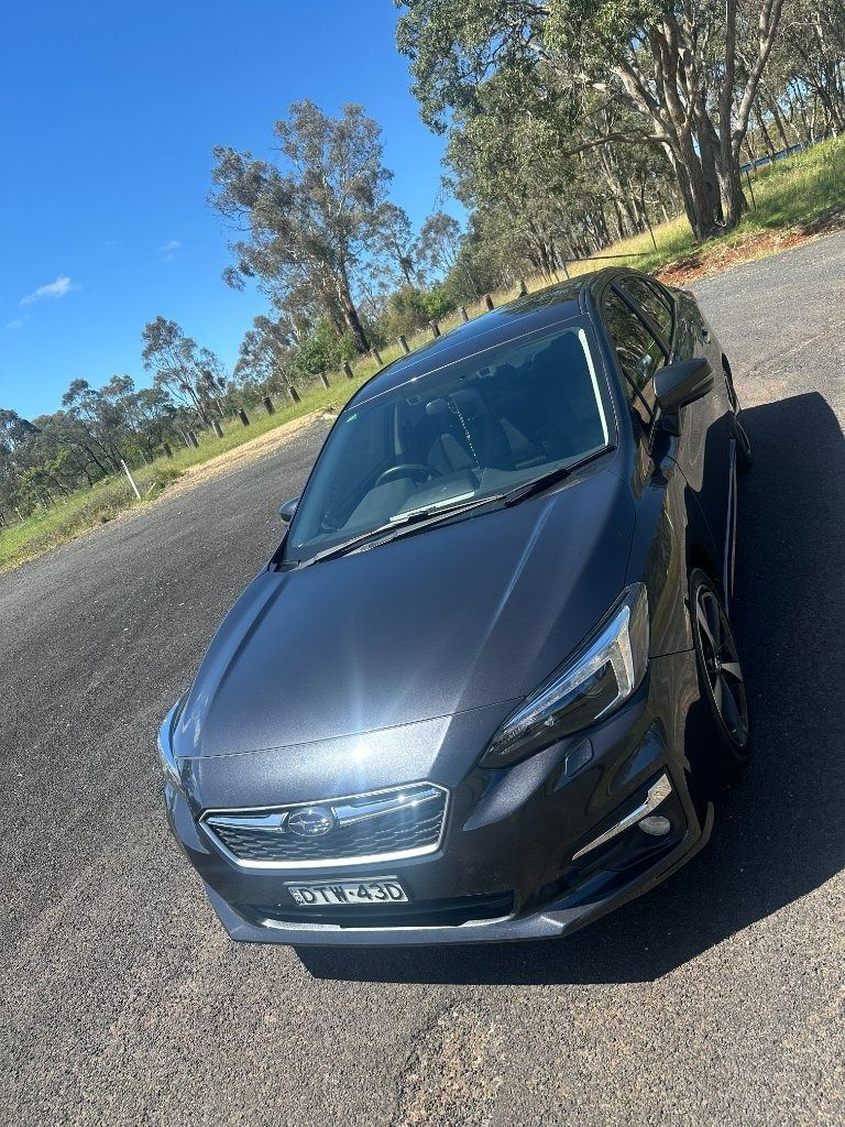 Dark Gray Sedan Parked on A Roadside Under a Clear Blue Sky — Diamond Glow Auto Detailing in Armidale, NSW