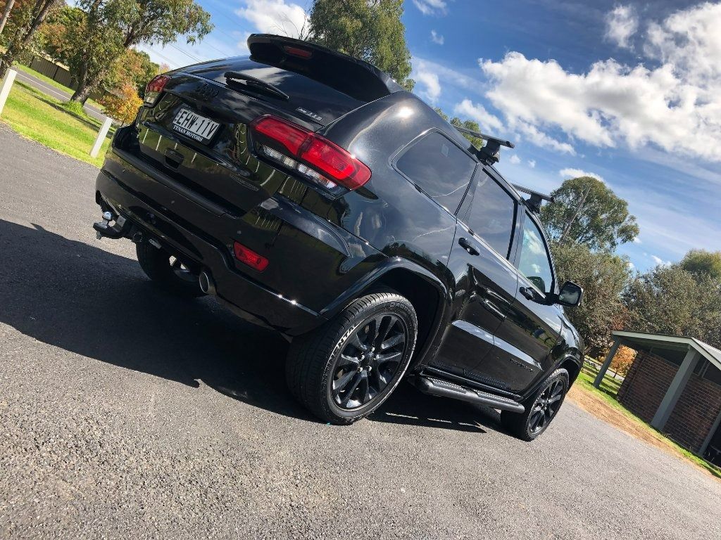 Black SUV Parked on A Driveway Under a Partly Cloudy Sky, — Diamond Glow Auto Detailing in Armidale, NSW